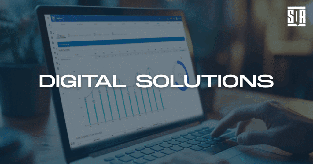 Close-up of a person using a laptop displaying data analytics dashboards, with the words 'Digital Solutions' overlaid—representing SQA Services’ technology-enabled quality and compliance tools.