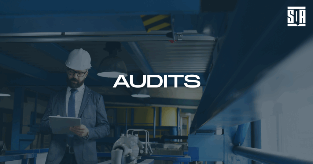 Engineer in safety helmet and suit reviewing a clipboard in an industrial facility, with the word 'AUDITS' and SQA logo overlayed on the image.