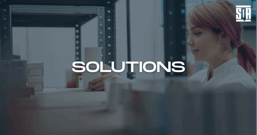Female quality professional inspecting packaged medical products on a shelf, with the word ‘Solutions’ overlaid — representing SQA Services’ quality and compliance solutions.
