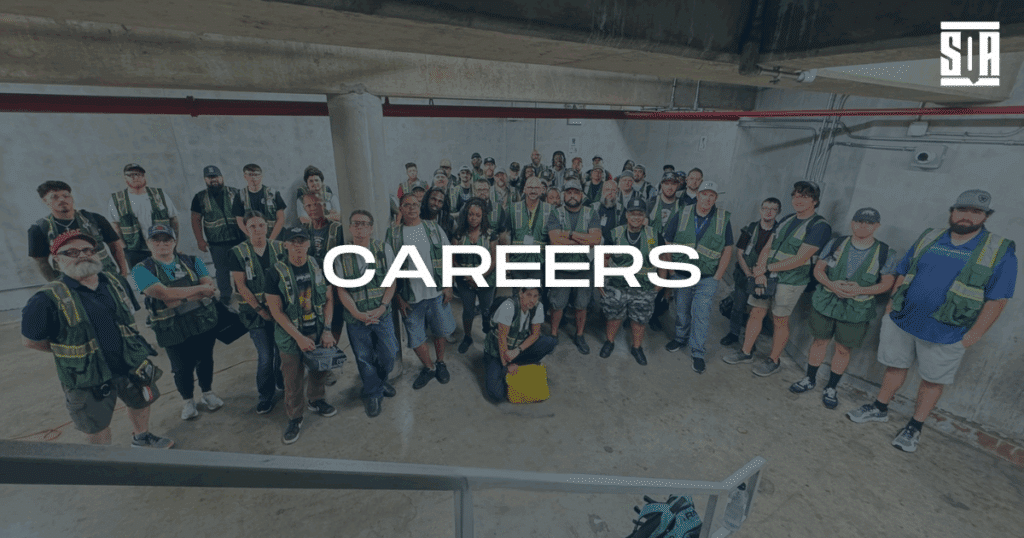 Group photo of SQA Services team members in safety vests standing in an industrial setting, with the word "CAREERS" prominently displayed in bold text.
